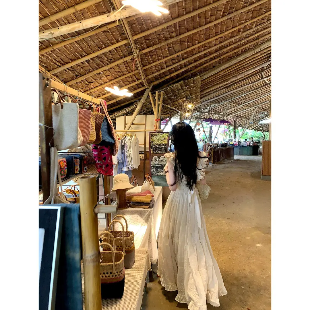 A Sweet Peach-Colored Yikett "Santorini" Heavy-Duty, Extra-Large Skirt Hem, Cinched Waist, Strap Dress for Women, Vacation Dress
