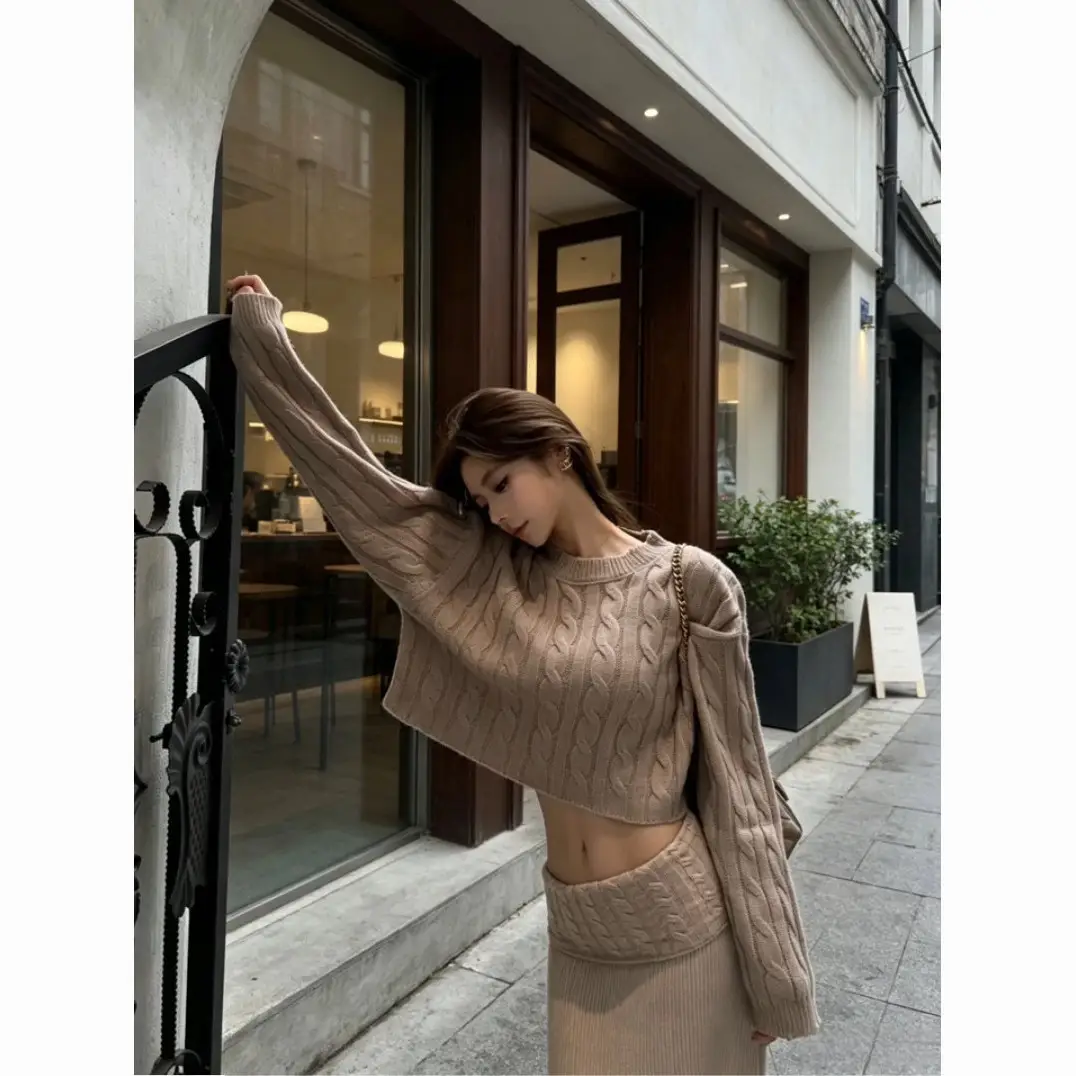 Early autumn women's elegant and sophisticated two-piece set: a round-neck, cable-knit short sweater paired with a high-waisted skirt
