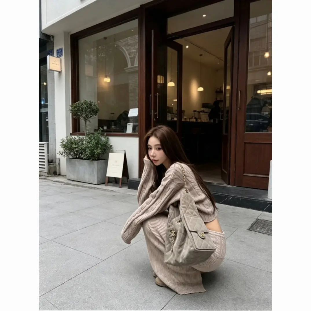 Early autumn women's elegant and sophisticated two-piece set: a round-neck, cable-knit short sweater paired with a high-waisted skirt
