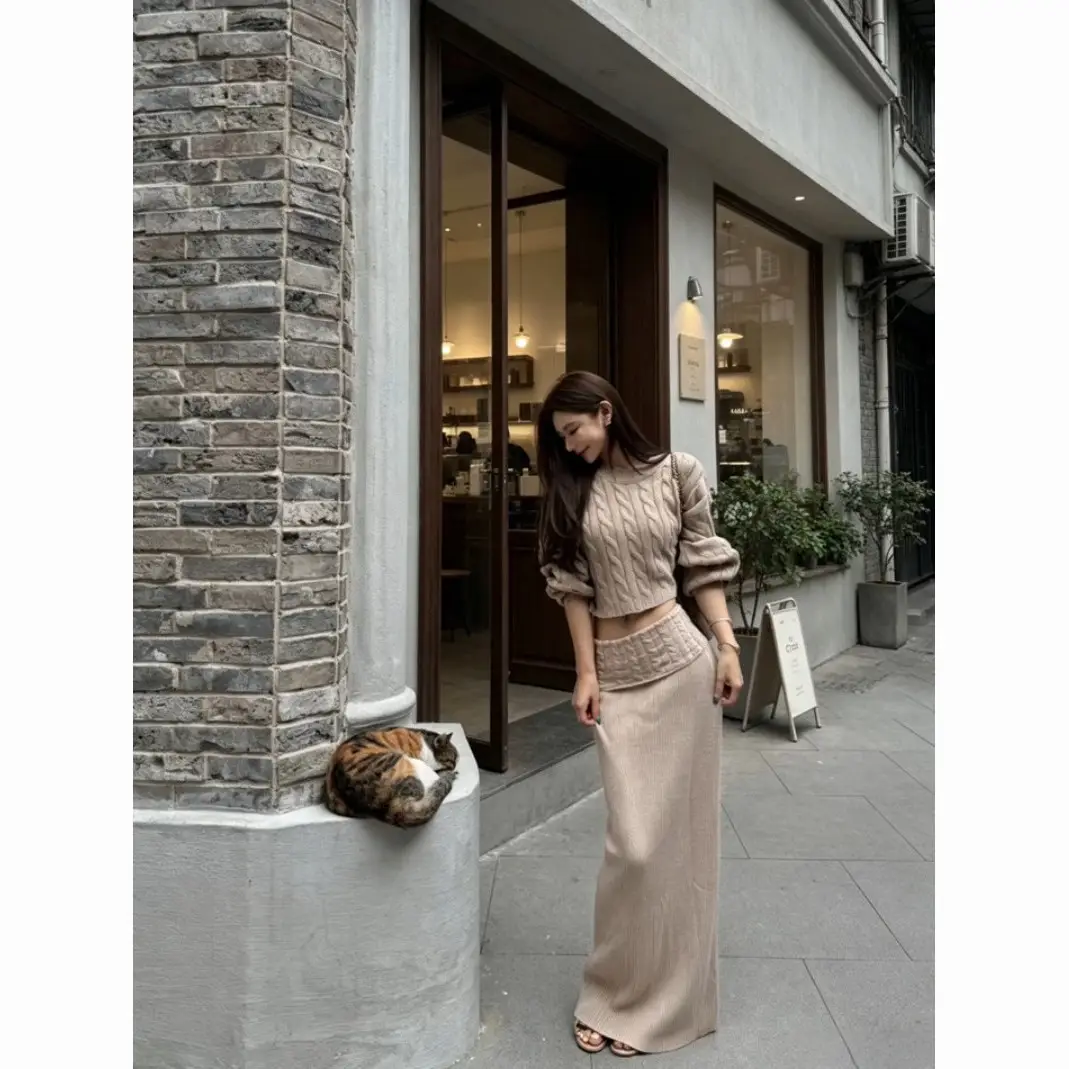 Early autumn women's elegant and sophisticated two-piece set: a round-neck, cable-knit short sweater paired with a high-waisted skirt