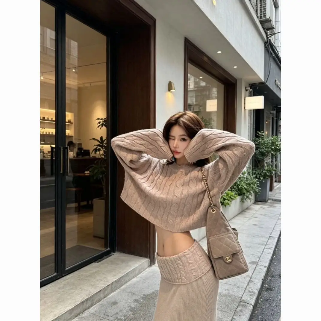 Early autumn women's elegant and sophisticated two-piece set: a round-neck, cable-knit short sweater paired with a high-waisted skirt — feature 1