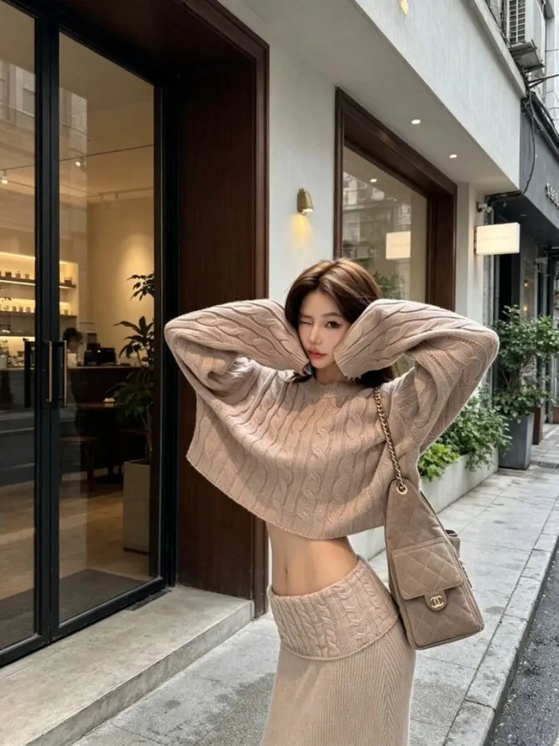 Early autumn women's elegant and sophisticated two-piece set: a round-neck, cable-knit short sweater paired with a high-waisted skirt — feature 2