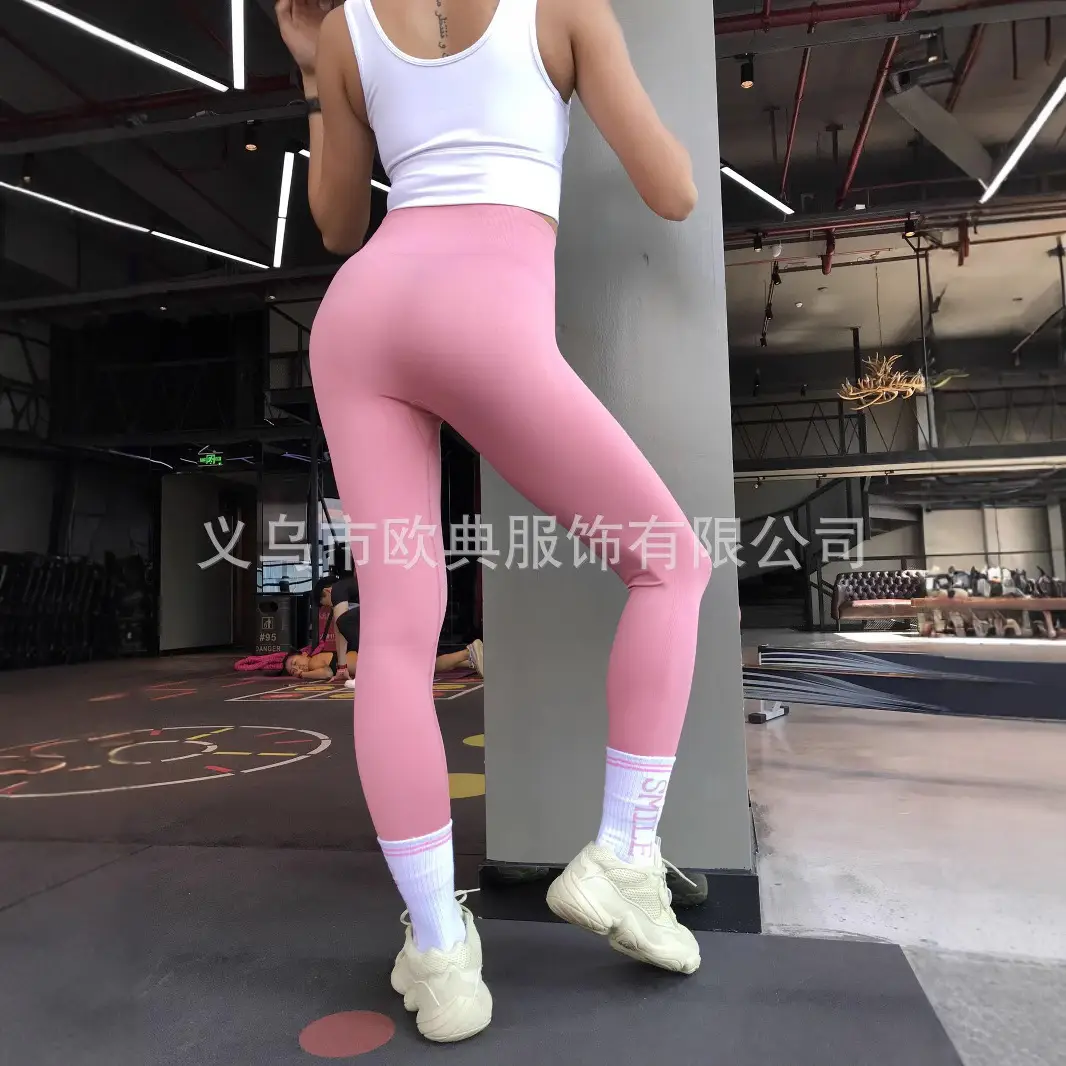 Red Seamless Fitness Pants for Women with White Sneakers - Image 4