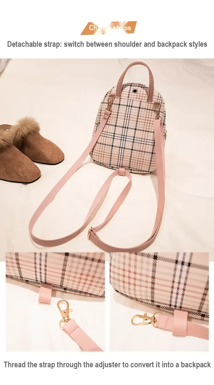 Back of pink plaid backpack showing detachable, adjustable straps and top handle.