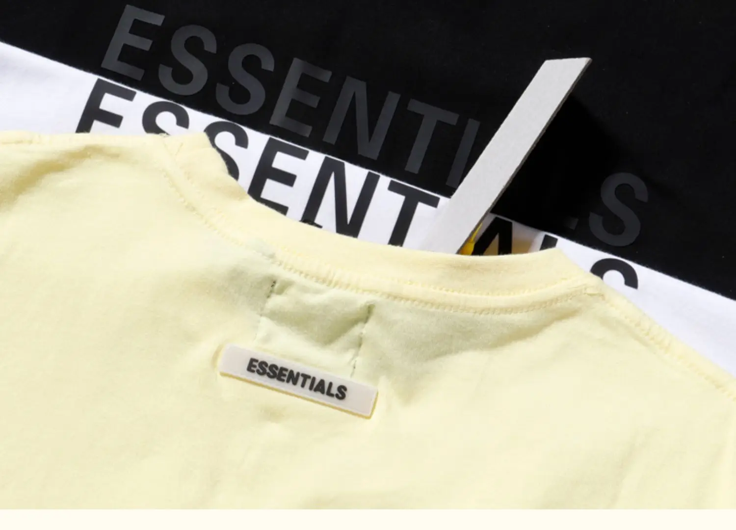 White Loose Fit T-Shirt with "Essentials" Print — feature 27