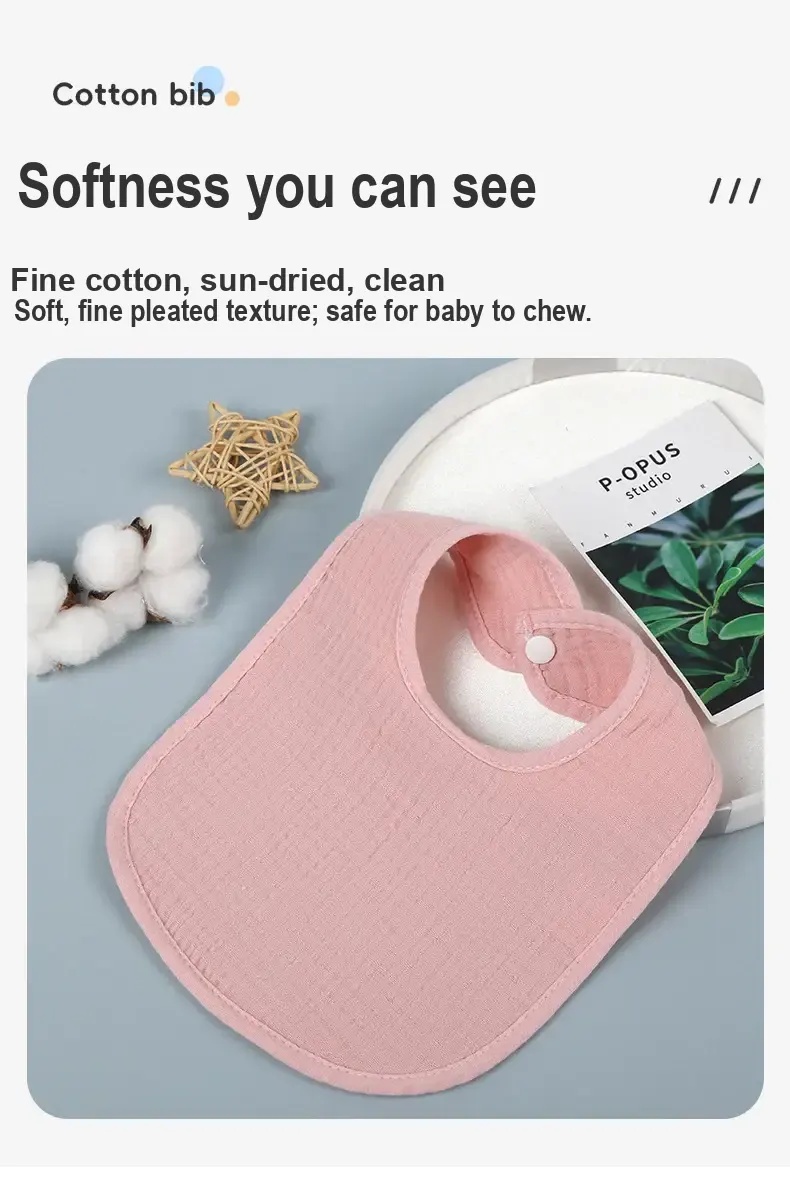 Close view of a pink gauze bib with a snap closure and stitched edging.