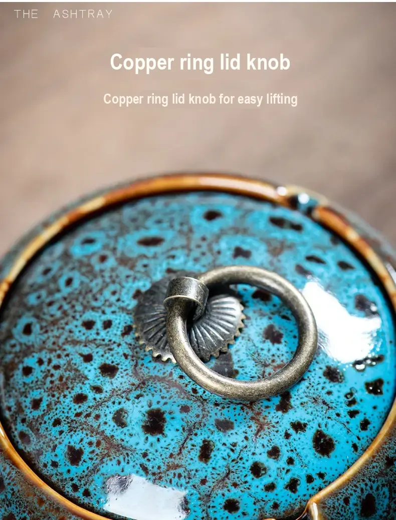 Close-up of the metal ring handle attached to a blue-speckled ashtray lid.
