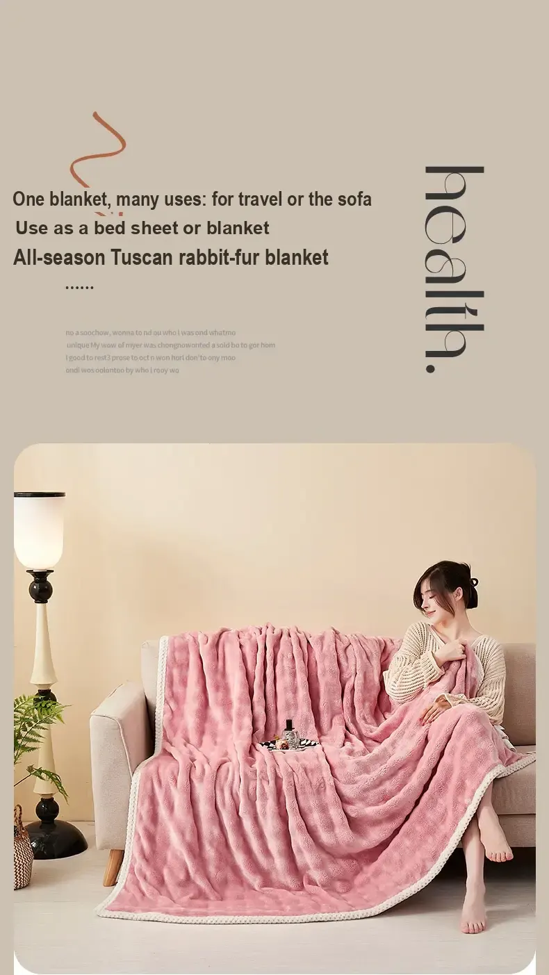 A person seated on a sofa with a pink blanket draped over it.