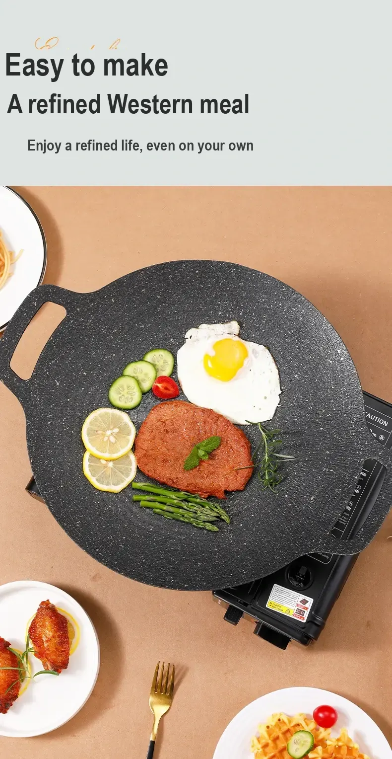 Overhead view of eggs and other food cooking on the speckled pan.