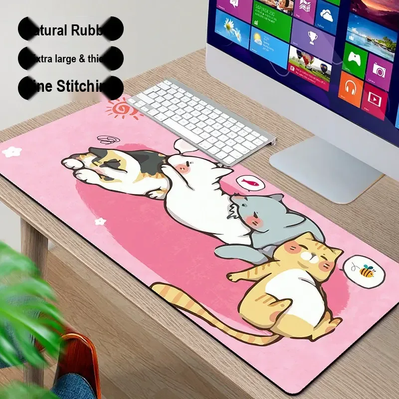 Pink desk mat printed with a group of cartoon cats