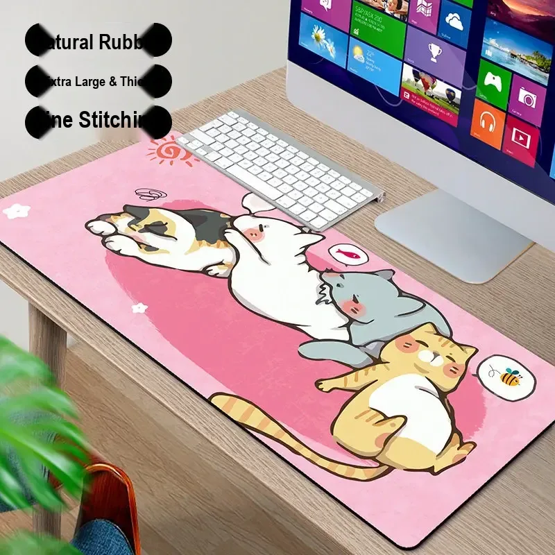 Pink desk mat printed with a group of cartoon cats