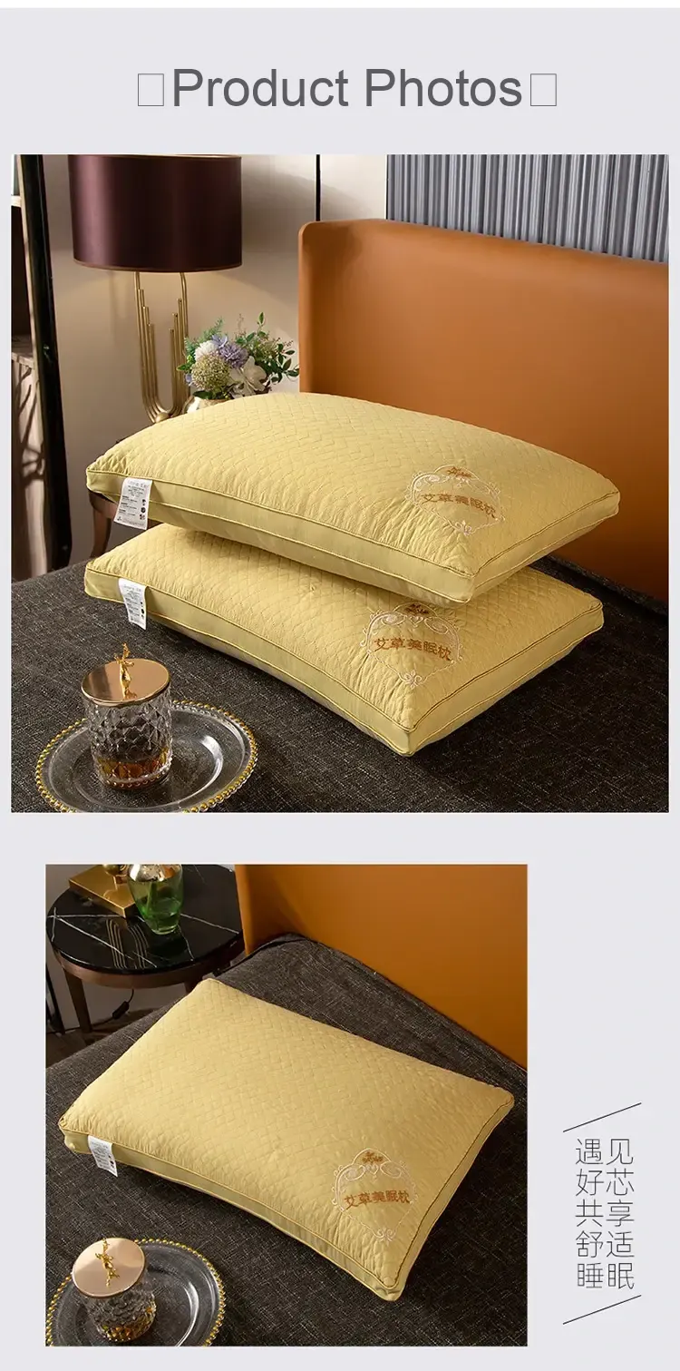 Two yellow embroidered pillows displayed on a bed.
