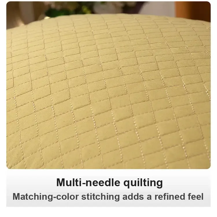 Close-up of the yellow pillow's quilted stitching.