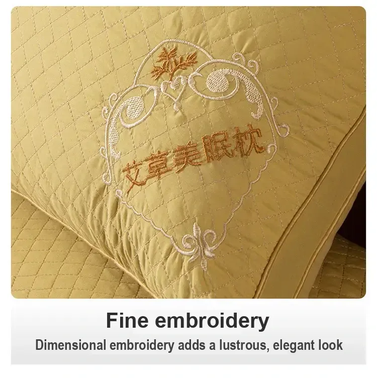 Close-up of decorative embroidery on the yellow pillow.