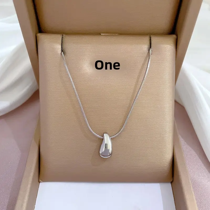 Gold Pendant Necklace with Black Circle Design - Image 7