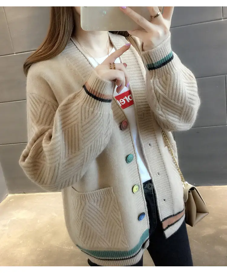 Angled front view of the beige cardigan with textured sleeves and two pockets.