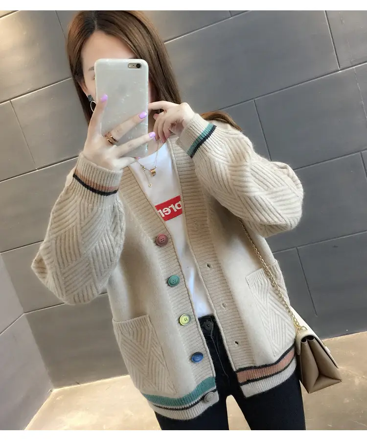 Model wearing the beige cardigan, showing its V-neck and striped hem.