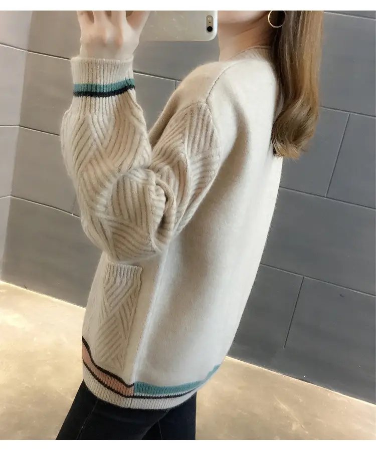 Back-side view of the beige cardigan with smooth back and textured sleeves.