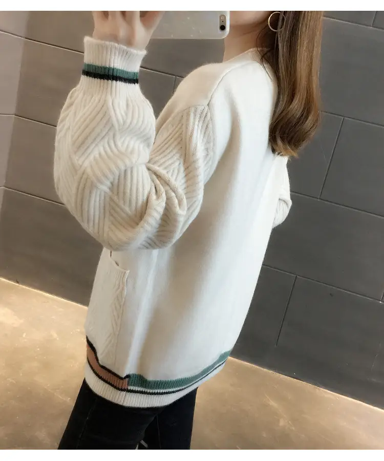 Back-side view of the white cardigan with textured sleeve and striped cuffs and hem.