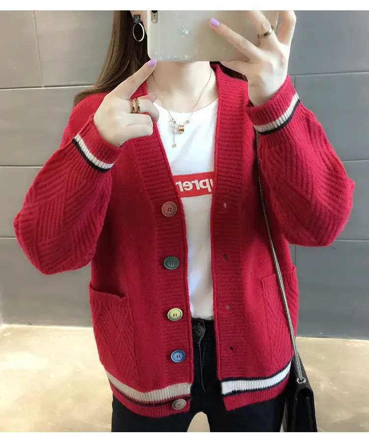 Front view of the red cardigan showing its striped cuffs and hem and button front.