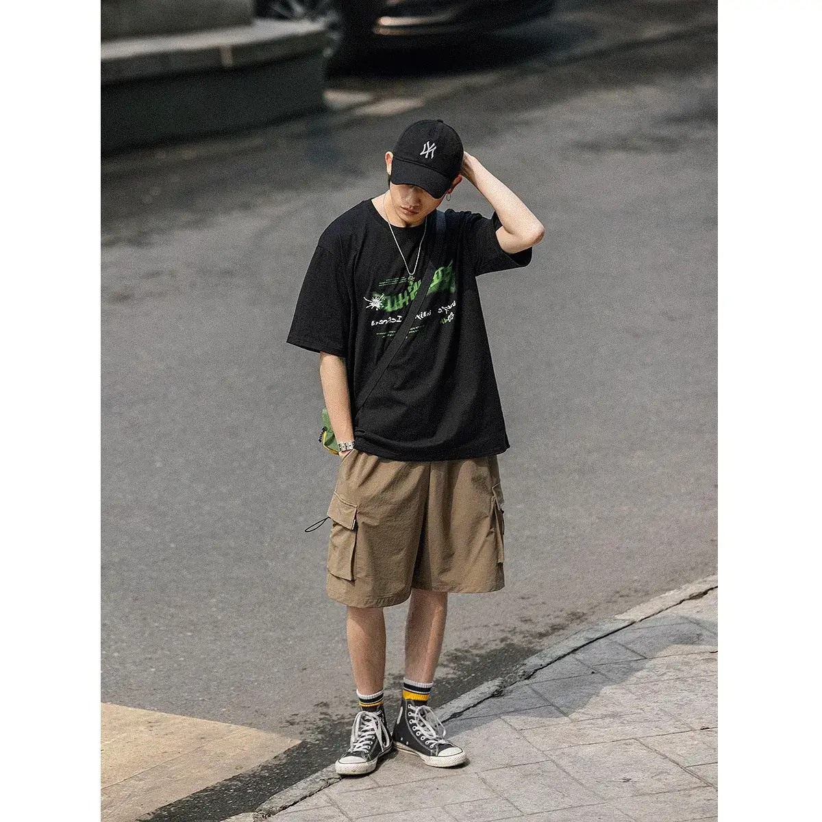 Men's Black Graphic Shorts with Cap and Sneakers - Image 5
