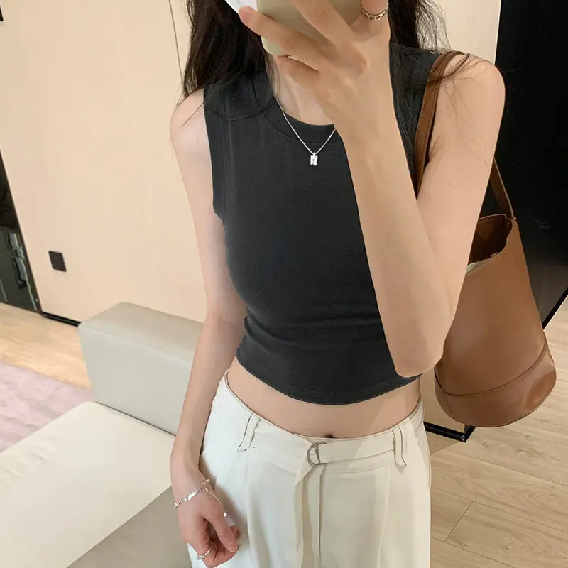 Black Sleeveless Top with Gold Necklace & Black Handbag - Image 4