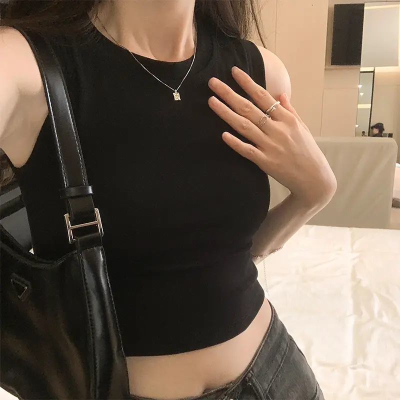 Black Sleeveless Top with Gold Necklace & Black Handbag - Image 2