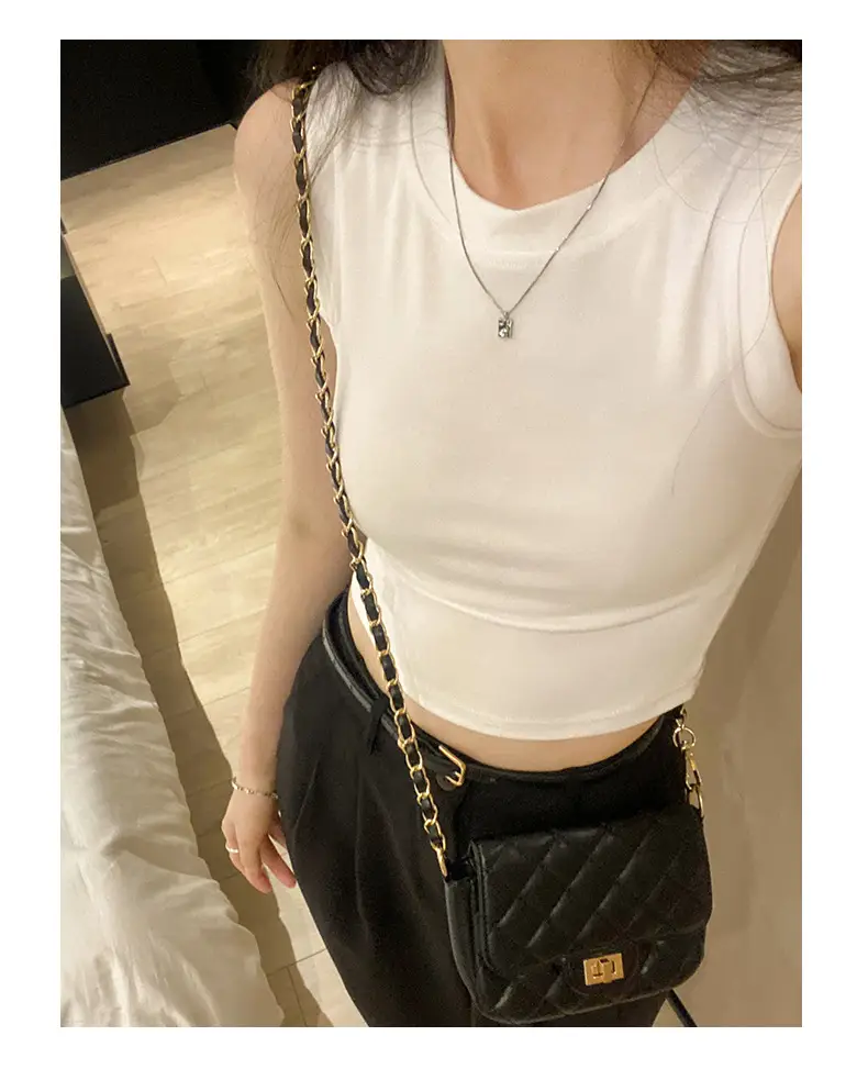Black Sleeveless Top with Gold Necklace & Black Handbag — feature 1