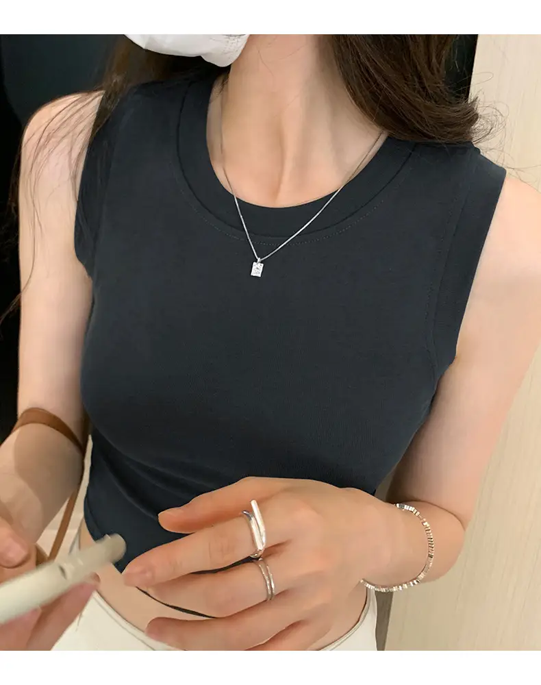 Black Sleeveless Top with Gold Necklace & Black Handbag — feature 23