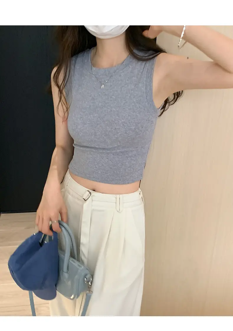 Black Sleeveless Top with Gold Necklace & Black Handbag — feature 8