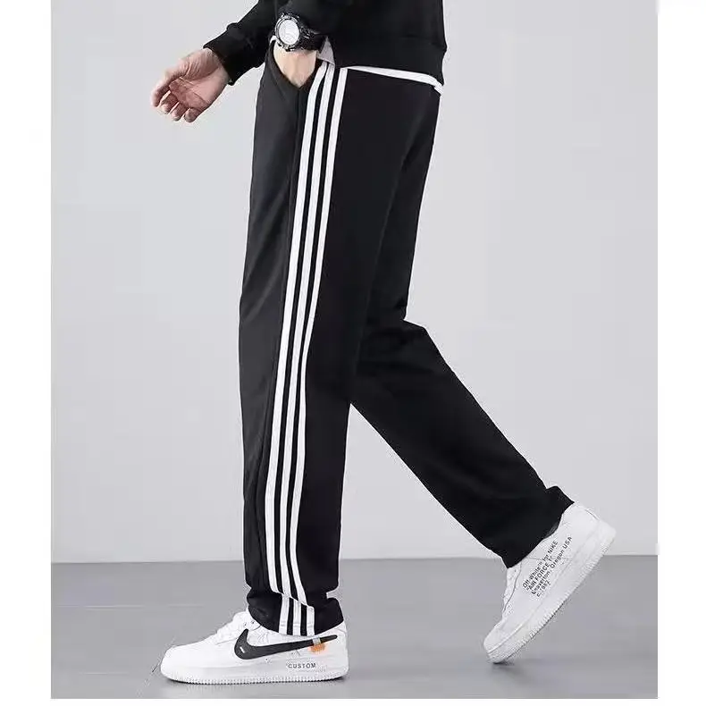 Men's Black Striped Track Pants with White Sneakers - Image 3
