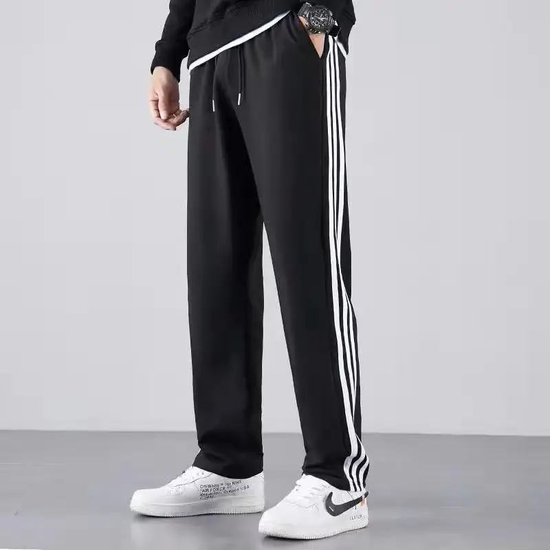 Men's Black Striped Track Pants with White Sneakers — feature 3