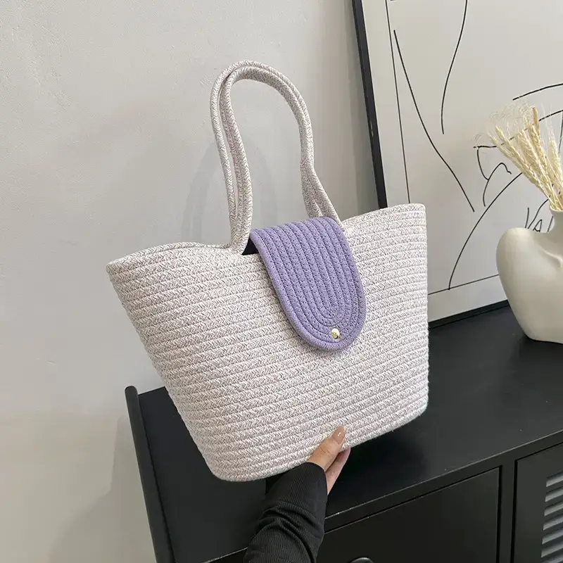 Women's woven straw tote bag with purple accent