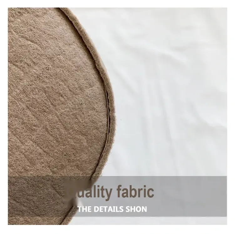 Close-up of the textured khaki bag material and stitched edge.