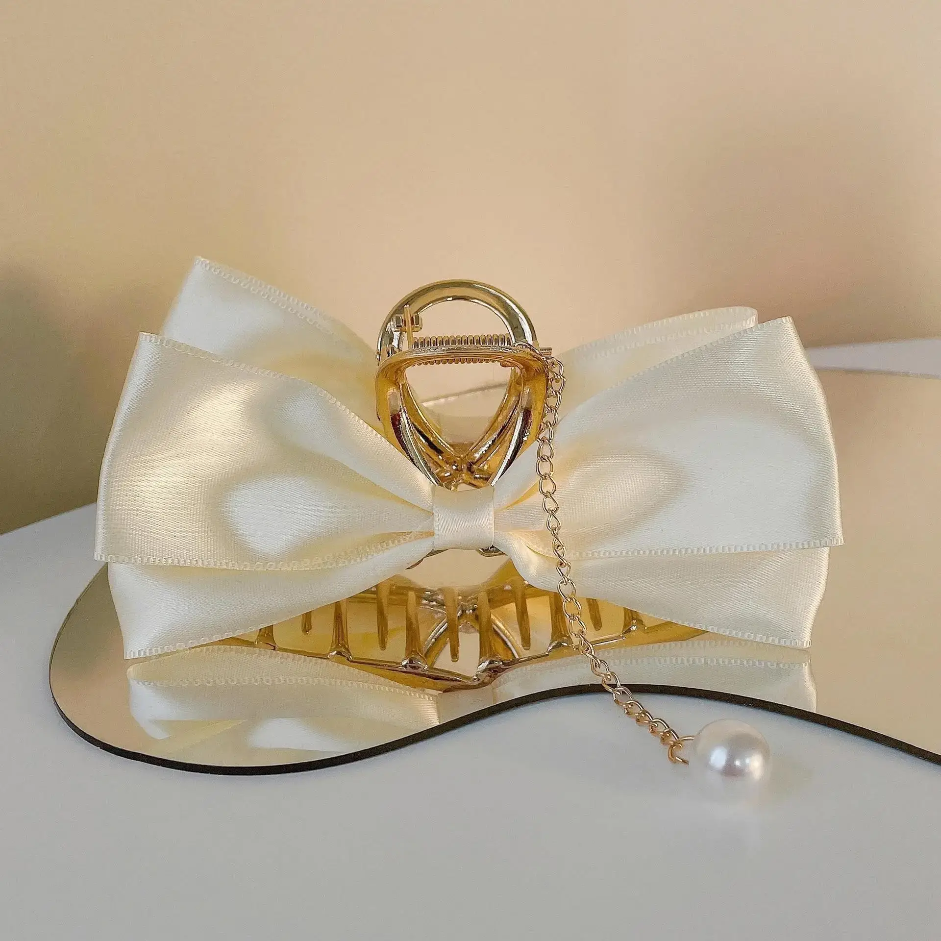 Beige cross bow tassel shark clip