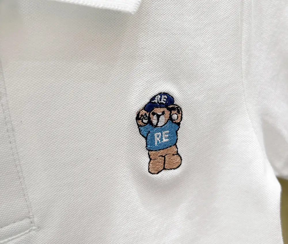Boys White Polo Shirt with Cartoon Logo Medium to XL — feature 9