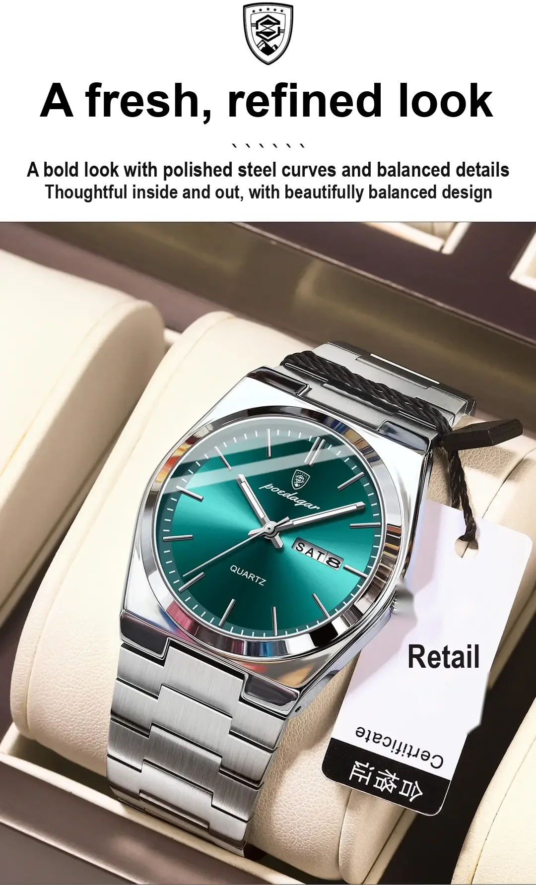 Green-dial silver watch on a cushion beside a tag.