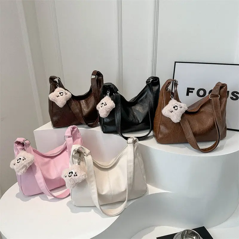 Women's Soft Leather Crossbody Bag with Cute Pom Pom Design