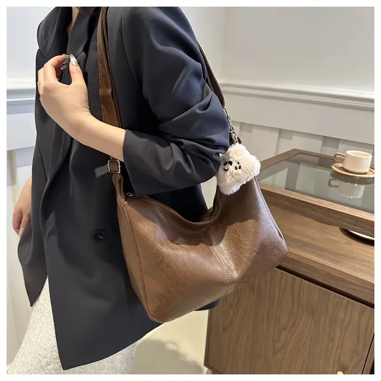 Women's Soft Leather Crossbody Bag with Cute Pom Pom Design — feature 10