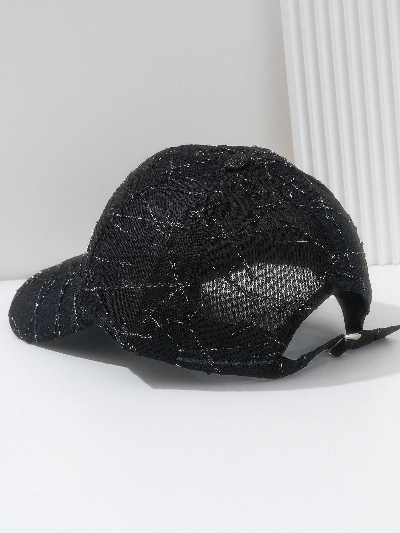 Black Quilted Travel Cap with Metal Button — feature 7
