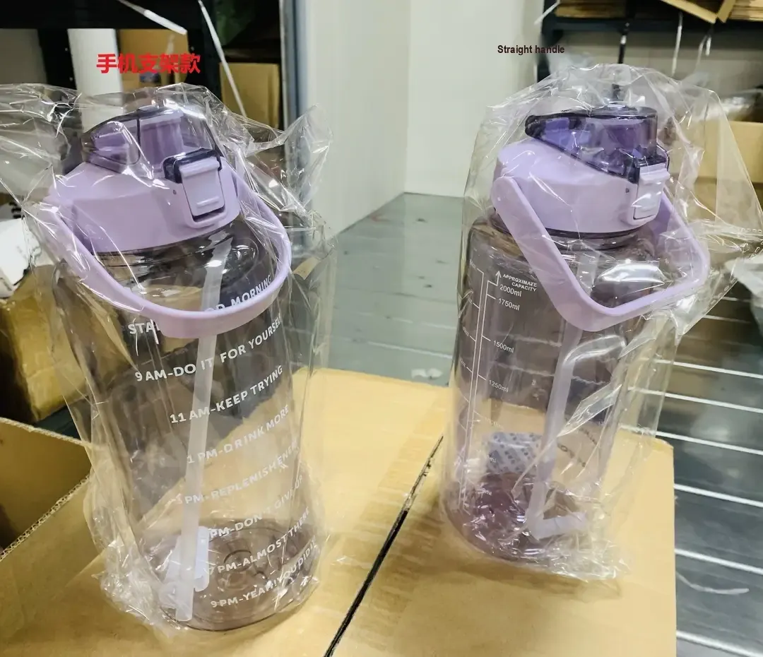 Two packaged purple bottles showing different lid and handle styles.