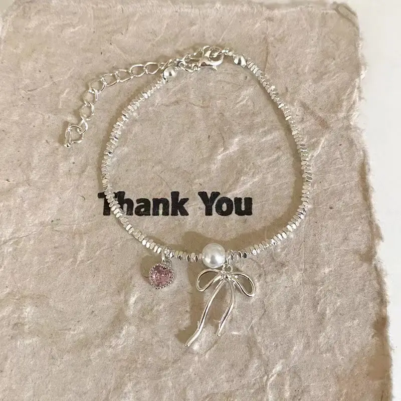 Broken Silver Bracelet with Love Bow & Pearl Accents — feature 8