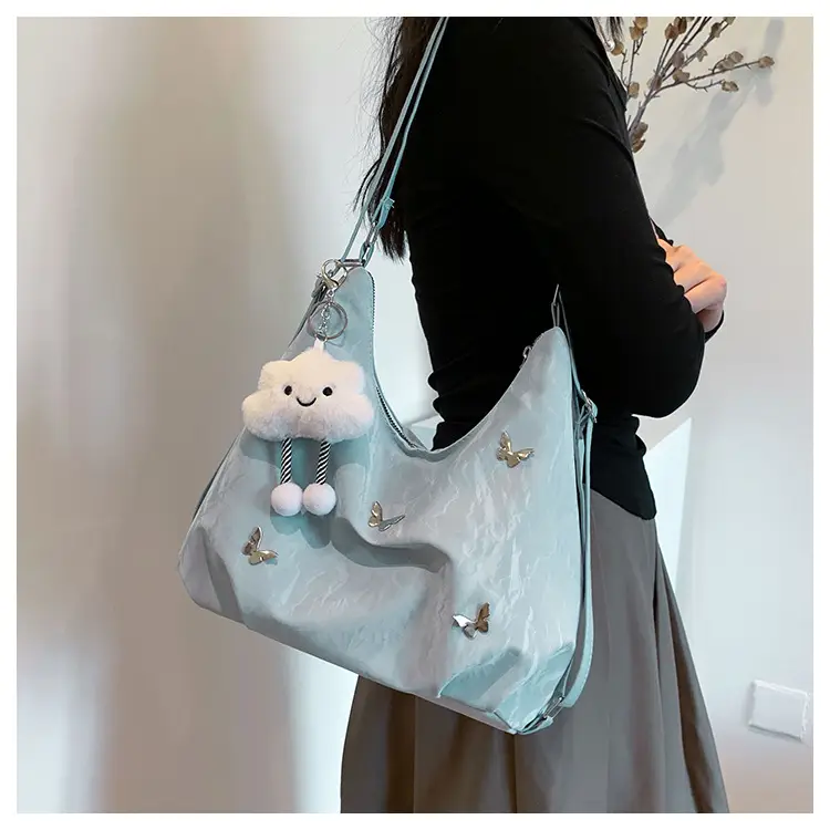 Silver Butterfly Shoulder Bag with Pom Pom Charm — feature 10