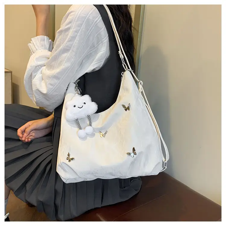 Silver Butterfly Shoulder Bag with Pom Pom Charm — feature 13