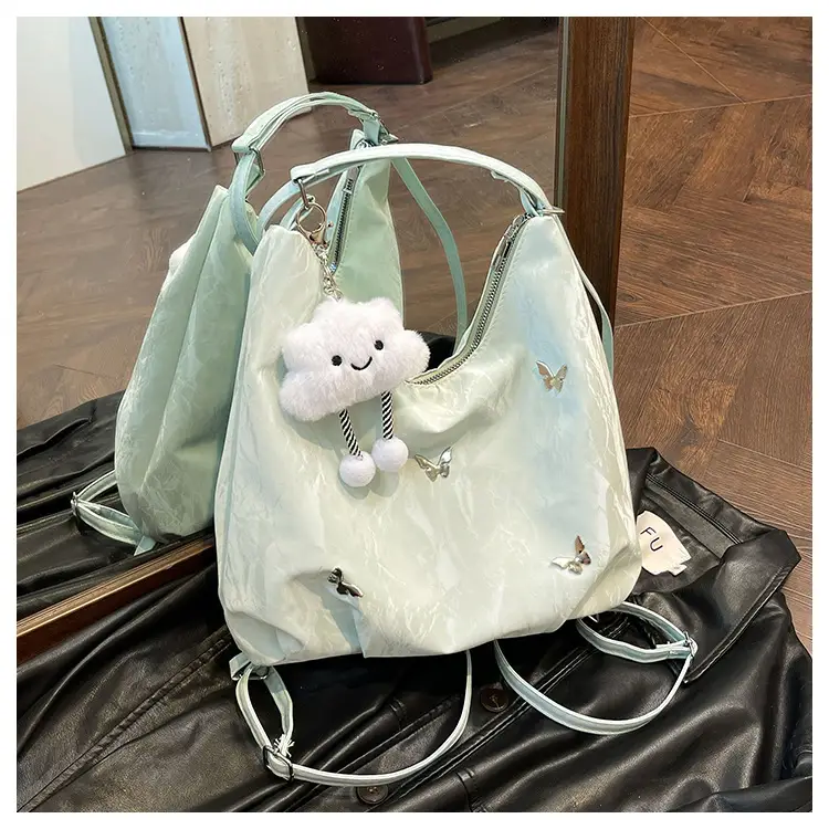 Silver Butterfly Shoulder Bag with Pom Pom Charm — feature 23