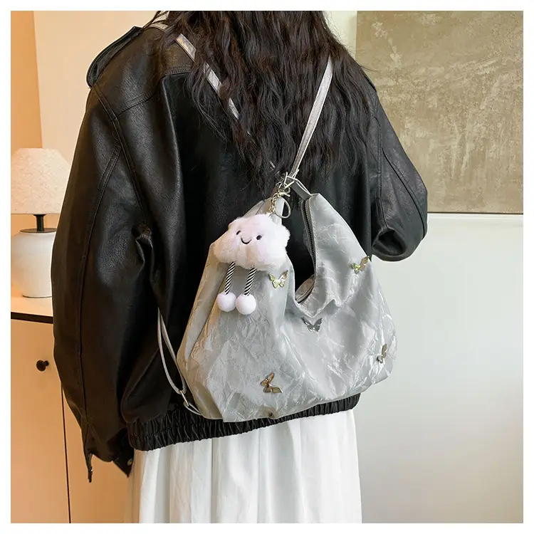 Silver Butterfly Shoulder Bag with Pom Pom Charm — feature 9