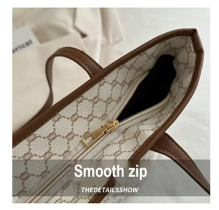 View inside tote showing zip closure and patterned lining