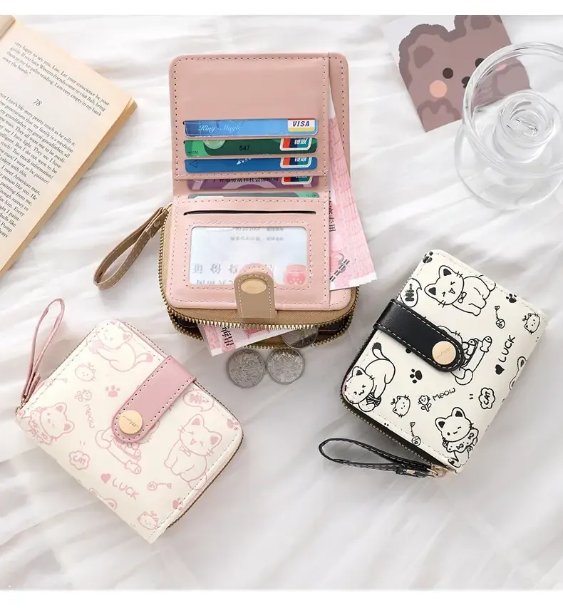 Three wallets in pink and black alongside an open pink wallet showing the inside.