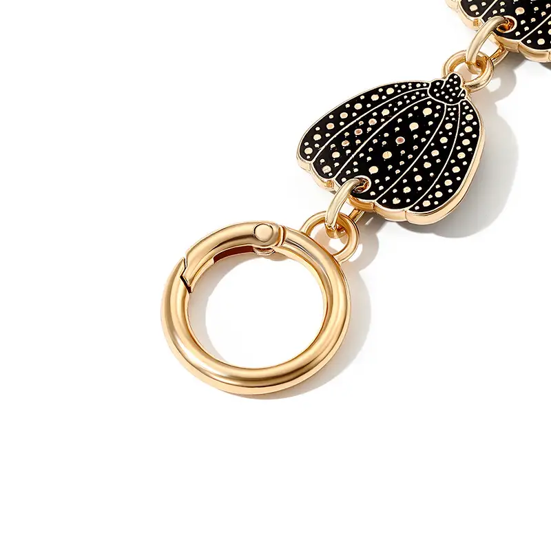 Heart-Shaped Gold Earrings with Black Polka Dot Design - Image 7