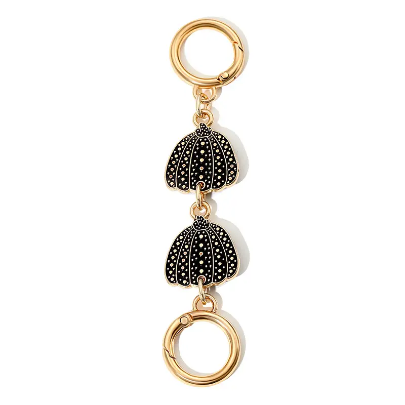 Heart-Shaped Gold Earrings with Black Polka Dot Design - Image 9